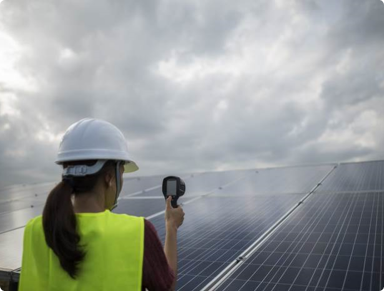 a woman inspecting a solar panel